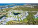 An aerial view of a community with meticulously manicured landscaping and serene water features at 8952 Scallop Way, Placida, FL 33946