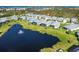 An aerial view of beautiful homes surrounding a tranquil pond with a fountain feature at 8952 Scallop Way, Placida, FL 33946