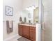 Bathroom featuring granite countertop, wood cabinets, glass enclosed shower, and neutral color palette at 8952 Scallop Way, Placida, FL 33946