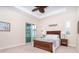 Bright bedroom with a tray ceiling, king bed, and sliding glass doors to the backyard at 8952 Scallop Way, Placida, FL 33946