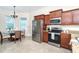Bright and airy dining area with chandelier, stainless steel refrigerator, and tile flooring at 8952 Scallop Way, Placida, FL 33946