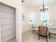 Bright dining area features a glass table set for four, with a nearby pantry for convenient storage at 8952 Scallop Way, Placida, FL 33946