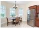 Breakfast area with tile floors, stainless steel refrigerator, and window with plantation shutters at 8952 Scallop Way, Placida, FL 33946