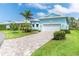 Attractive one-story home with a brick-paved driveway and two-car garage at 8952 Scallop Way, Placida, FL 33946
