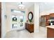 View of the spacious foyer featuring tile flooring, double doors, and access to kitchen at 8952 Scallop Way, Placida, FL 33946