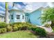 Charming home entrance with lush landscaping, decorative shutters, and double front doors at 8952 Scallop Way, Placida, FL 33946