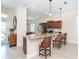 View of the kitchen and breakfast bar featuring granite countertops, stainless steel appliances, and bar stool seating at 8952 Scallop Way, Placida, FL 33946