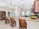 Open concept kitchen with island featuring granite countertops, tile flooring, and pendant lighting at 8952 Scallop Way, Placida, FL 33946
