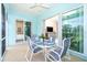 Comfortable lanai featuring an outdoor dining set and views through sliding glass doors into the living spaces at 8952 Scallop Way, Placida, FL 33946