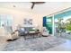 Inviting living room with ample seating, a ceiling fan, and access to the lanai through sliding glass doors at 8952 Scallop Way, Placida, FL 33946