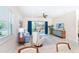 Bright living room with stylish furnishings, ceiling fan, TV, and sliding glass doors leading to outdoor space at 8952 Scallop Way, Placida, FL 33946