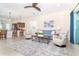 Inviting living room with blue accents, comfortable seating, and open to the kitchen at 8952 Scallop Way, Placida, FL 33946