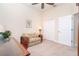 Cozy home office with ceiling fan featuring a desk, comfortable wicker settee, and closet at 8952 Scallop Way, Placida, FL 33946