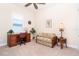 Bright home office with shuttered window, ceiling fan, desk, chair and comfortable wicker settee at 8952 Scallop Way, Placida, FL 33946