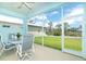 Relaxing screened patio with ceiling fan and table set offers beautiful views of the backyard at 8952 Scallop Way, Placida, FL 33946
