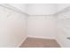 Walk-in closet featuring carpeted flooring, white walls, and white wire shelving at 8952 Scallop Way, Placida, FL 33946