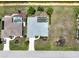 Aerial view showcasing a well-maintained property featuring a screened pool, landscaped yard, and a concrete driveway at 9064 Bantry Bay Blvd, Englewood, FL 34224