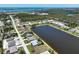 Scenic aerial view of a lakeside community with lush landscaping and beautiful homes near a tranquil lake at 9064 Bantry Bay Blvd, Englewood, FL 34224