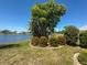 Lush landscaping and vibrant flowerbeds enhance the view of the lake, creating a peaceful retreat at 9064 Bantry Bay Blvd, Englewood, FL 34224