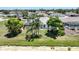 The backyard showcases a screened lanai with palm trees, well maintained landscaping, and an inviting lawn at 9064 Bantry Bay Blvd, Englewood, FL 34224