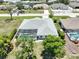 Backyard view featuring a screened in pool, palm trees, and privacy landscaping at 9064 Bantry Bay Blvd, Englewood, FL 34224