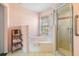 Bathroom featuring a glass shower, tiled floors, and a separate tub at 9064 Bantry Bay Blvd, Englewood, FL 34224