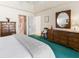 Bright bedroom with a double dresser, vaulted ceilings, teal carpet, and access to bathroom at 9064 Bantry Bay Blvd, Englewood, FL 34224