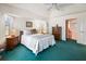 Bright bedroom featuring a vaulted ceiling, a ceiling fan, and teal-colored carpet at 9064 Bantry Bay Blvd, Englewood, FL 34224