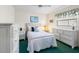 Cozy bedroom features white furniture, ceiling fan, and bright green carpet at 9064 Bantry Bay Blvd, Englewood, FL 34224