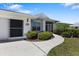 Inviting home exterior showcasing a well-kept lawn, walkway, and lush shrubs near the front entrance at 9064 Bantry Bay Blvd, Englewood, FL 34224