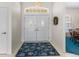 Bright foyer showcasing double doors, a decorative rug, and an elegant chandelier, creating a welcoming entrance at 9064 Bantry Bay Blvd, Englewood, FL 34224