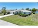 Well-maintained home with a lush front lawn, fresh landscaping, and a concrete driveway enhancing curb appeal at 9064 Bantry Bay Blvd, Englewood, FL 34224