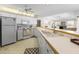 Well-lit kitchen with white appliances, countertops, and cabinetry, open to the adjacent living area at 9064 Bantry Bay Blvd, Englewood, FL 34224