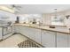 Bright kitchen featuring white cabinetry, updated appliances, and a functional breakfast bar with ample counter space at 9064 Bantry Bay Blvd, Englewood, FL 34224