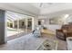 Bright living room with open access to the pool area and kitchen, featuring comfortable furniture at 9064 Bantry Bay Blvd, Englewood, FL 34224