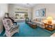 Cozy living room featuring comfortable seating, a piano, and a sliding glass door offering natural light and views at 9064 Bantry Bay Blvd, Englewood, FL 34224