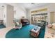 Bright living room featuring comfortable seating, a piano, and sliding glass doors leading to outdoor space at 9064 Bantry Bay Blvd, Englewood, FL 34224
