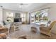 Cozy living room with wicker furniture and sliding glass doors leading to the pool area at 9064 Bantry Bay Blvd, Englewood, FL 34224