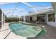 Sparkling pool surrounded by tile decking within screened enclosure offers relaxation and privacy at 9064 Bantry Bay Blvd, Englewood, FL 34224