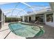 Sparkling pool surrounded by tile decking within screened enclosure offers relaxation and privacy at 9064 Bantry Bay Blvd, Englewood, FL 34224