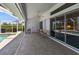 Covered patio with two chairs and a ceiling fan next to a pool at 9064 Bantry Bay Blvd, Englewood, FL 34224