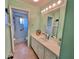 Well-lit bathroom with neutral tones, vanity storage, and convenient access to the shower, offering a clean and functional space at 9270 Little Gasparilla Is, Placida, FL 33946