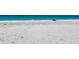 Wide beach with turquoise water and beach chairs at 9270 Little Gasparilla Is, Placida, FL 33946