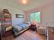 Charming bedroom with a single bed, wood floors, and a bright window offering pleasant natural light at 9270 Little Gasparilla Is, Placida, FL 33946