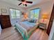 Bright bedroom with wood floors, closet, and tropical bedding, offering a comfortable and stylish retreat at 9270 Little Gasparilla Is, Placida, FL 33946