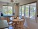 Bright dining area with large windows, offering picturesque views of the lush surroundings and natural light at 9270 Little Gasparilla Is, Placida, FL 33946