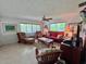 Inviting living room featuring comfortable seating, bright windows, and a relaxing atmosphere at 9270 Little Gasparilla Is, Placida, FL 33946