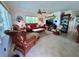 Bright living room featuring wicker furniture, nautical decor, and tile flooring at 9270 Little Gasparilla Is, Placida, FL 33946