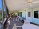 Inviting screened-in patio with comfortable seating and ceiling fans for relaxing outdoor living at 9270 Little Gasparilla Is, Placida, FL 33946