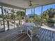 Relaxing screened-in patio with dining table offers outdoor living with scenic views and fresh air at 9270 Little Gasparilla Is, Placida, FL 33946